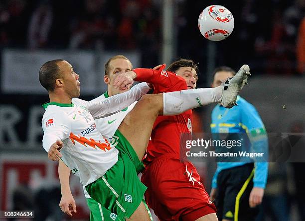Milivoje Novakovic of Koeln battles for the ball with Mikael Silvestre of Bremen during the Bundesliga match between 1.FC Koeln and SV Werder Bremen...
