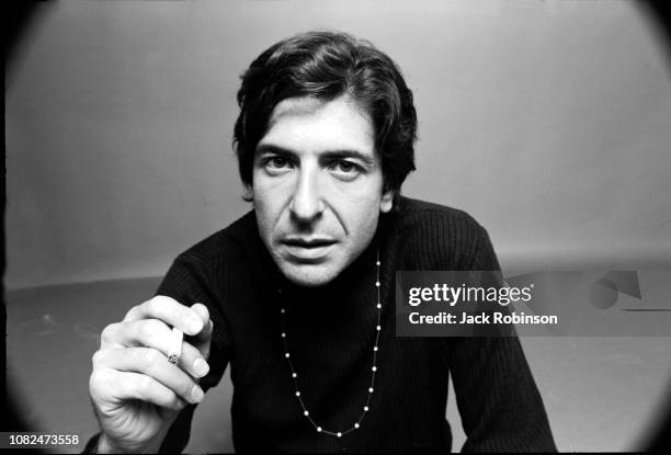 Portrait of Canadian poet, novelist, and musician Leonard Cohen , dressed in black, as he holds a cigarette in one hand, August 1967.