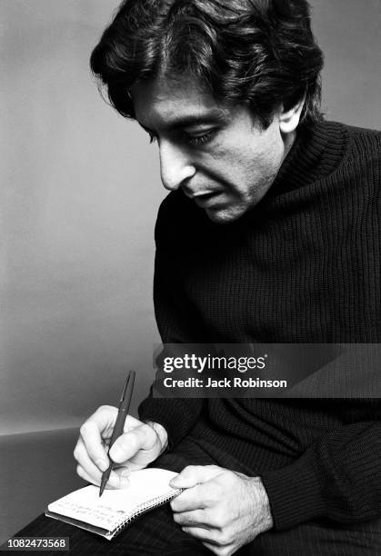 Portrait of Canadian poet, novelist, and musician Leonard Cohen , dressed in black, as writes in a notebook, August 1967.