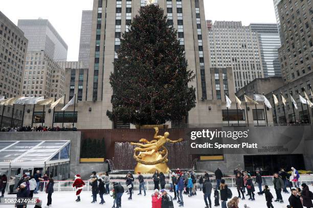 Ice skaters are joined by a man dressed as Santa Claus at The Rink at Rockefeller Center on December 14, 2018 in New York City. Rockefeller Center,...