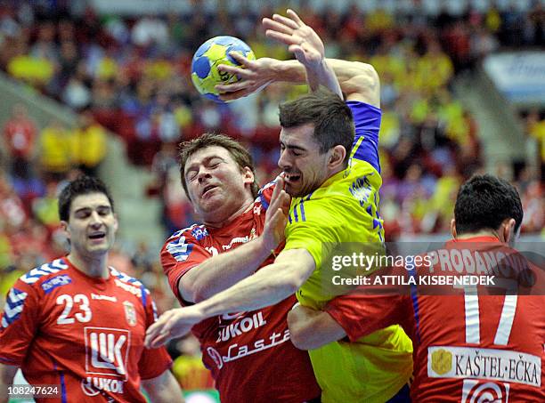 Sweden's Dalibor Doder vies with Serbia's Alem Toskic and Rajko Prodanovic as Serbian's Nenad Vuckovic looks on during their 22nd Mens Handball...