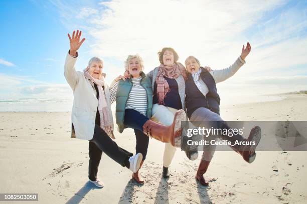 the secret of a happy life is to live it - group arm in arm stock pictures, royalty-free photos & images