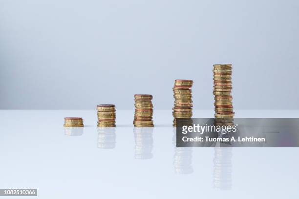 ascending stacks of coins - coins stockfoto's en -beelden