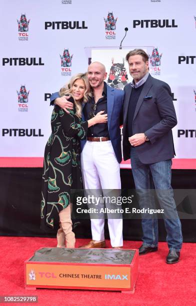 Ellen K, Pitbull and John Travolta attend the Hand And Footprint Ceremony Honoring Pitbull at TCL Chinese Theatre on December 14, 2018 in Hollywood,...