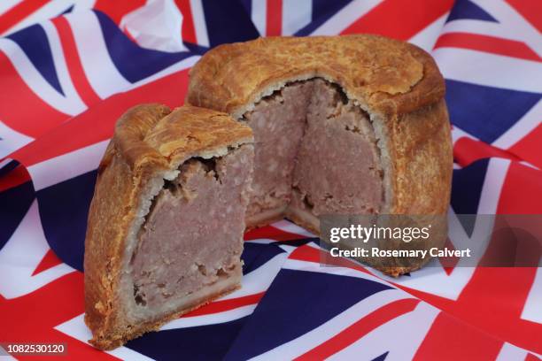 british pork pie & slice on union jacks. - savoury pie stock pictures, royalty-free photos & images