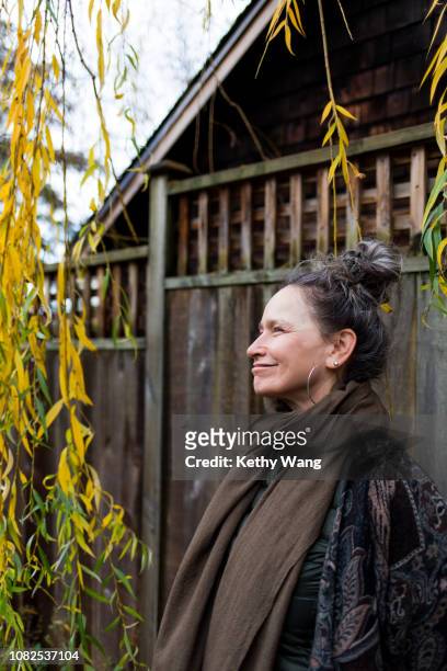 Fashionable older woman under a willow tree