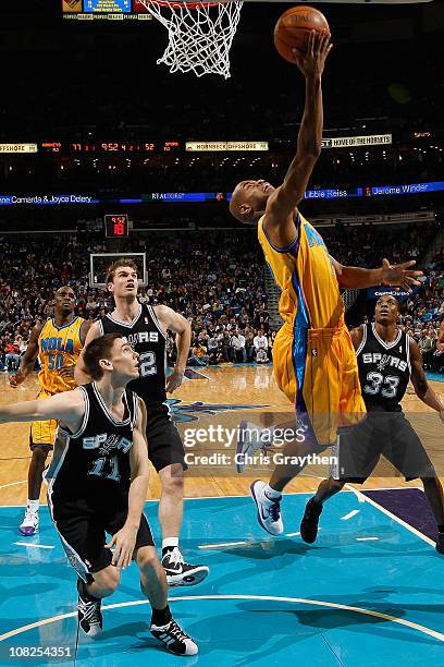 Jarrett Jack of the New Orleans Hornets shoots the ball over Chris Quinn of the San Antonio Spurs at the New Orleans Arena on January 22, 2011 in New...
