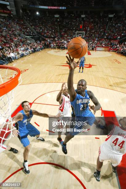 Jason Richardson of the Orlando Magic shoots the ball over Kyle Lowry and Chuck Hayes of the Houston Rockets on January 22, 2011 at the Toyota Center...