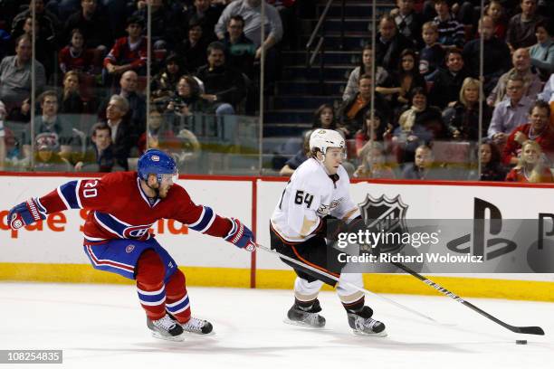 Brandon McMillan of the Anaheim Ducks skates with the puck while being defended by James Wisniewski of the Montreal Canadiens during the NHL game at...