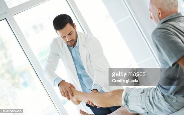 ankle examination. - old man feet stock pictures, royalty-free photos & images