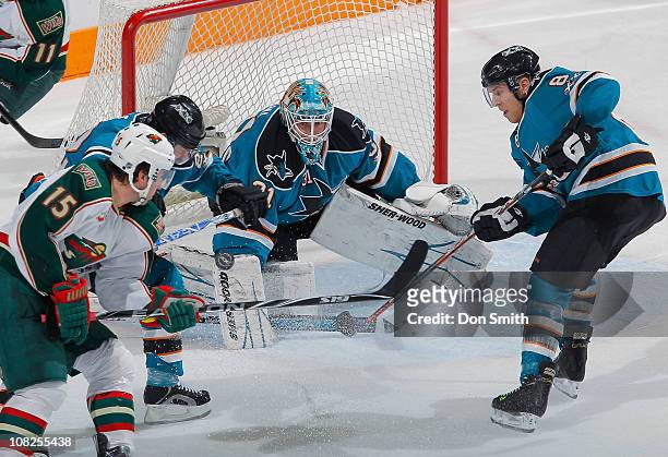 Antti Niemi and Joe Pavelski of the San Jose Sharks defend against Andrew Brunette of the Minnesota Wild during an NHL game on January 22, 2011 at HP...