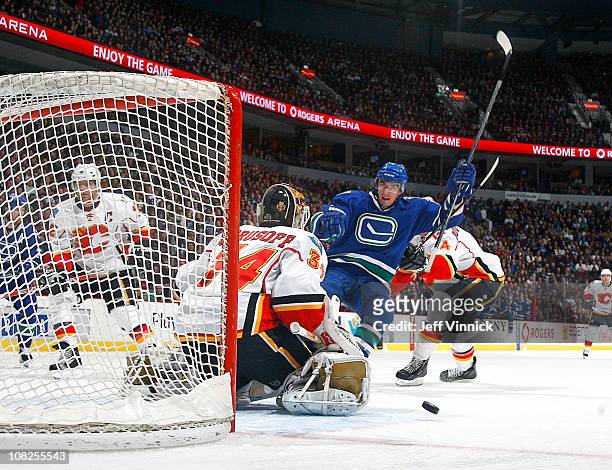 Alex Burrows of the Vancouver Canucks celebrates a first-period goal on Miikka Kiprusoff of the Calgary Flames during their game at Rogers Arena on...