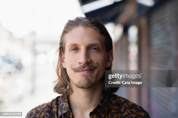 portrait confident young male hipster with mustache - handlebar moustache stock pictures, royalty-free photos & images