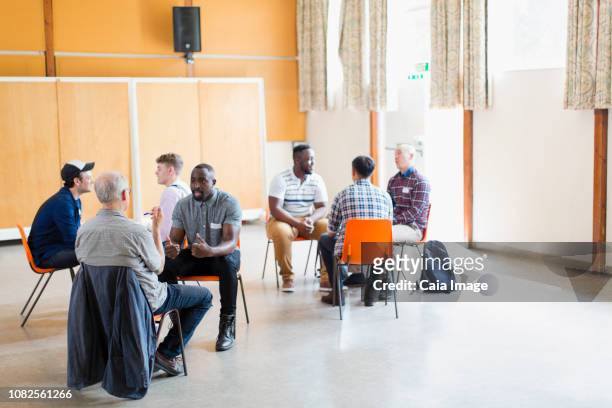men talking in group therapy - alternative therapy stock pictures, royalty-free photos & images