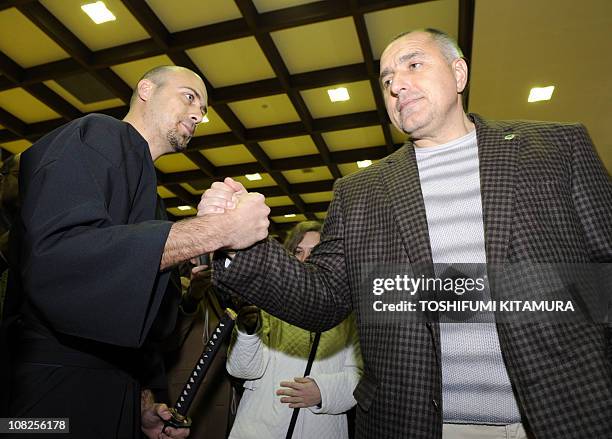 Bulgarian Prime Minister Boyko Borisov shakes hands with 30-year-old Bulgarian student attending Osaka University, Slavov Petko , who takes lessons...