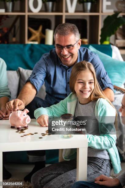 happy family saving money - kids saving money stock pictures, royalty-free photos & images
