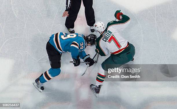 Logan Couture of the San Jose Sharks faces off against Matt Cullen of the Minnesota Wild during an NHL game on January 22, 2011 at HP Pavilion at San...