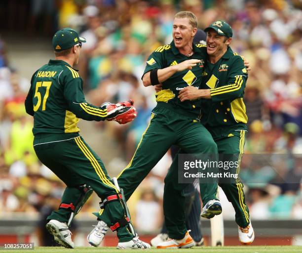 Xavier Doherty of Australia celebrates with Brad Haddin and David Hussey after taking the wicket of Paul Collingwood of England during the...