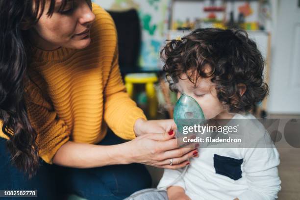 little boy makes inhalation at home - coughing stock pictures, royalty-free photos & images