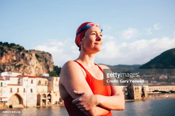 female swimmer standing by the sea - swimming goggles stock pictures, royalty-free photos & images