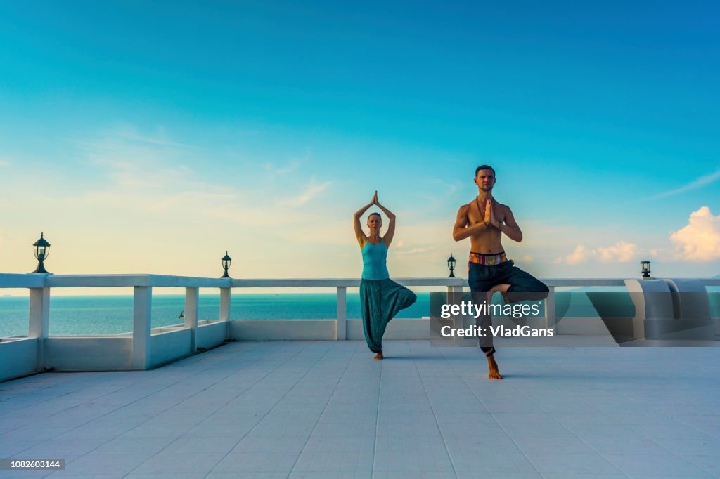 Man and Woman practicing yoga