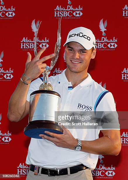 Martin Kaymer of Germany poses with the trophy on the 18th green after winning the 2011 Abu Dhabi HSBC Golf Championship at the Abu Dhabi Golf Club...