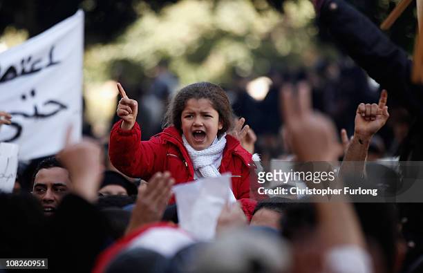 Young girl joins protesters who marched from the rural areas of Tunisia to campaign outside the prime minister's office for the remnants of the old...