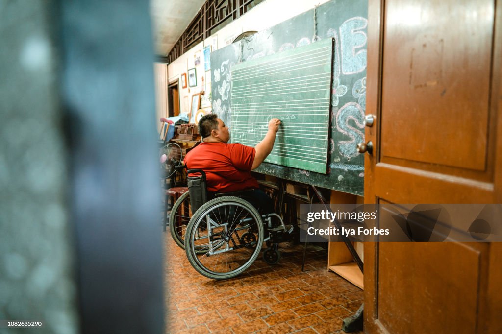Differently abled Filipino woman teaching