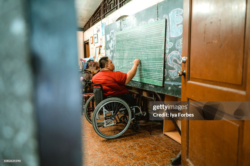 Differently abled Filipino woman teaching