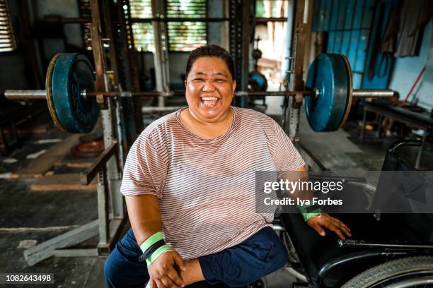 differently abled filipino powerlifter smiling - positive healthy middle age woman stock pictures, royalty-free photos & images