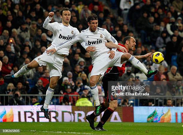 Ricardo Carvalho and Sergio Ramos of Real Madrid fight for a high ball with Ivan Ramis of Mallorca during the La Liga match between Real Madrid and...