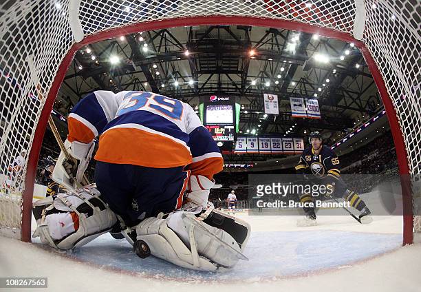 Jochen Hecht of the Buffalo Sabres watches a shot by teammate Tyler Ennis elude Rick DiPietro of the New York Islanders at 4:58 of the second period...