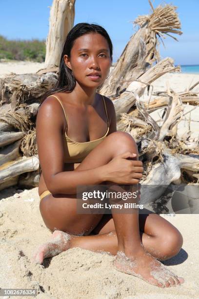 dark skin young asian woman sat on the beach - hot filipina women stockfoto's en -beelden