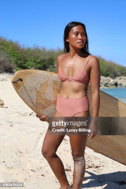 young woman with surf board at the beach in the sun - hot filipina women stock pictures, royalty-free photos & images