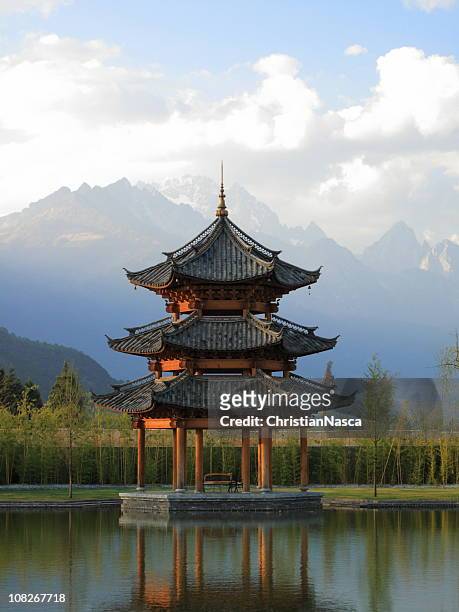 chinese pagoda pavilion with mountains in background - pagoda stock pictures, royalty-free photos & images