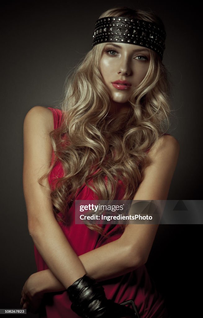 Fashion studio portrait of beautiful woman on dark background