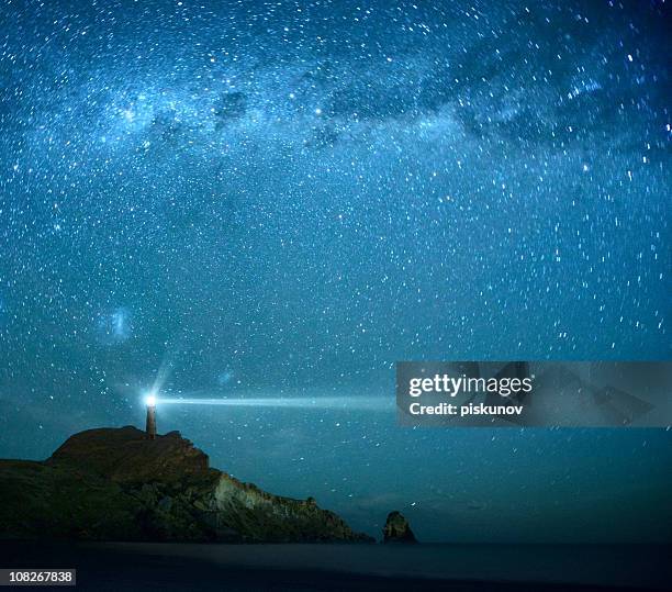 lighthouse under milky way stars - new zealand night stock pictures, royalty-free photos & images