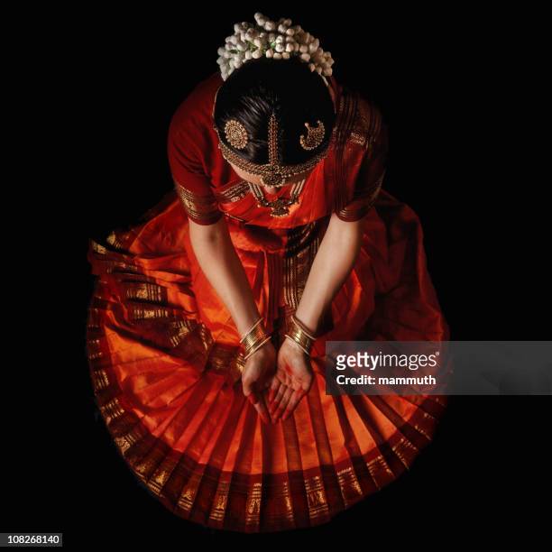 indian dancer praying before the holy dance - indian dance stock pictures, royalty-free photos & images