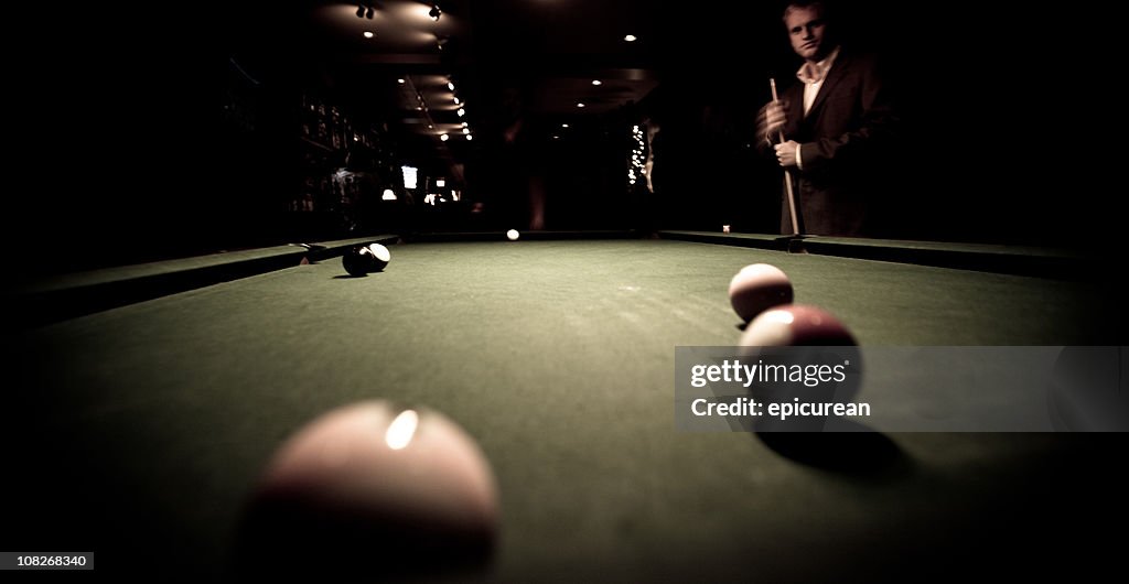 Shooting pool at a bar - contemplating next shot