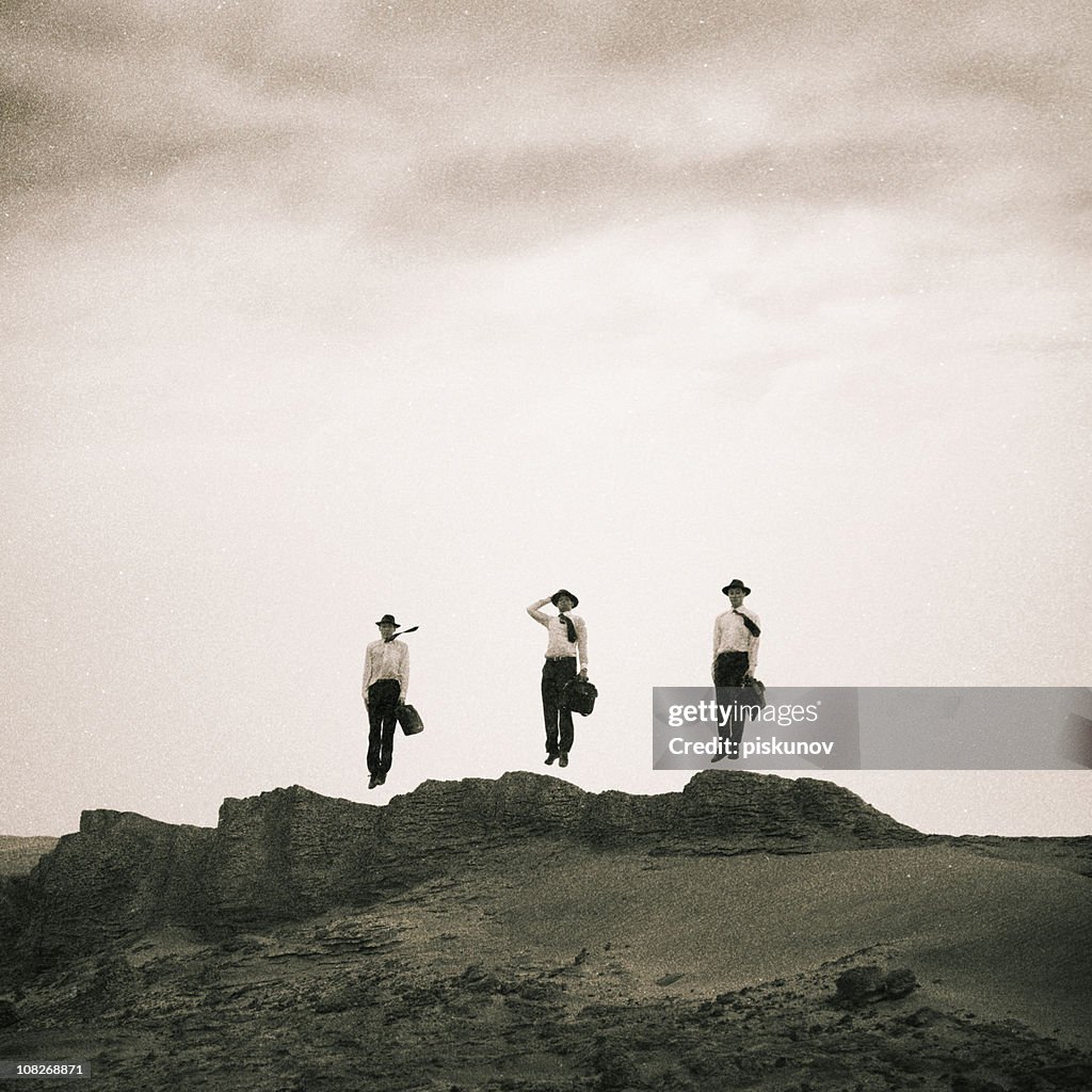 Three Men Jumping on Sand Dunes