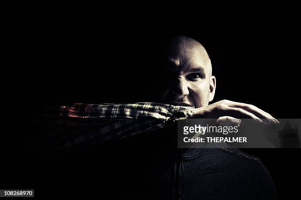 man with a severed arm in his mouth - cannibalism stock pictures, royalty-free photos & images