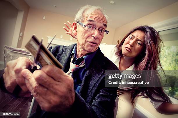 cutting up the credit cards - father and grown up daughter stock pictures, royalty-free photos & images