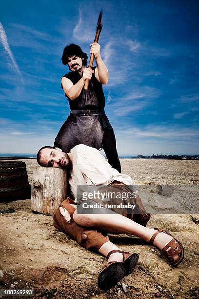 medieval executioner swinging axe to chop off man's head - executioner stock pictures, royalty-free photos & images
