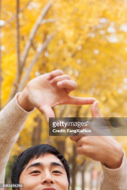chinese man making frame formation with hands - make a change stock pictures, royalty-free photos & images