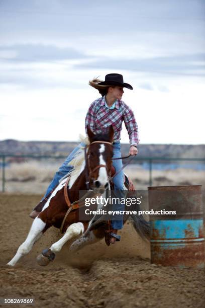 portrait of cowgirl barrel racing at sunset - rodeo stock pictures, royalty-free photos & images