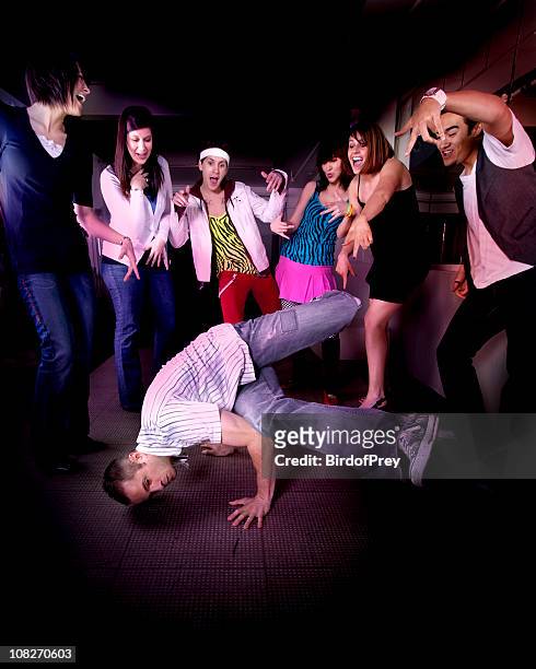 man breakdancing with crowd of people cheering him on - freestyle dance stock pictures, royalty-free photos & images