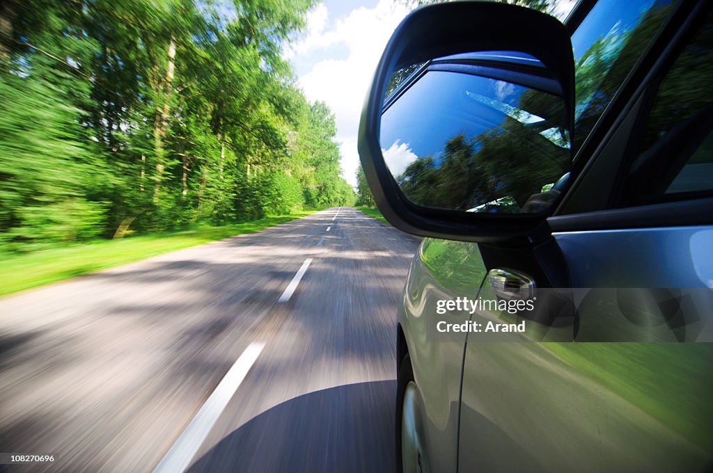 View from side of fast moving car