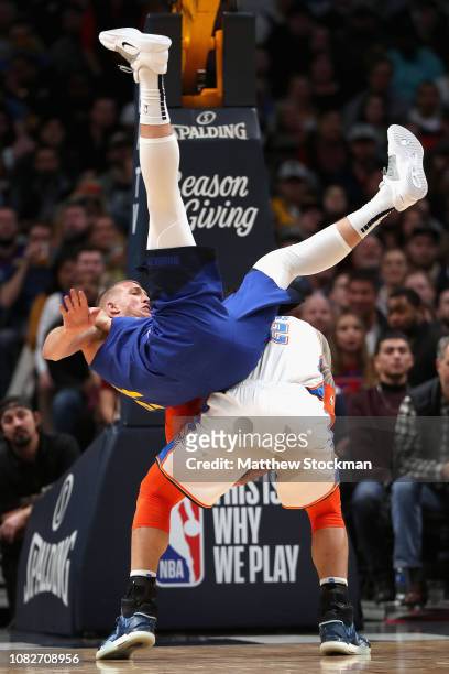 Mason Plumlee of the Denver Nuggets goes over the top of Steven Adams of the Oklahoma City Thunder to try and block a shot in the fourth quarter at...