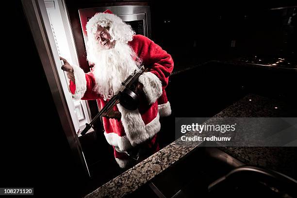 santa raiding refrigerator - christmas thief stock pictures, royalty-free photos & images