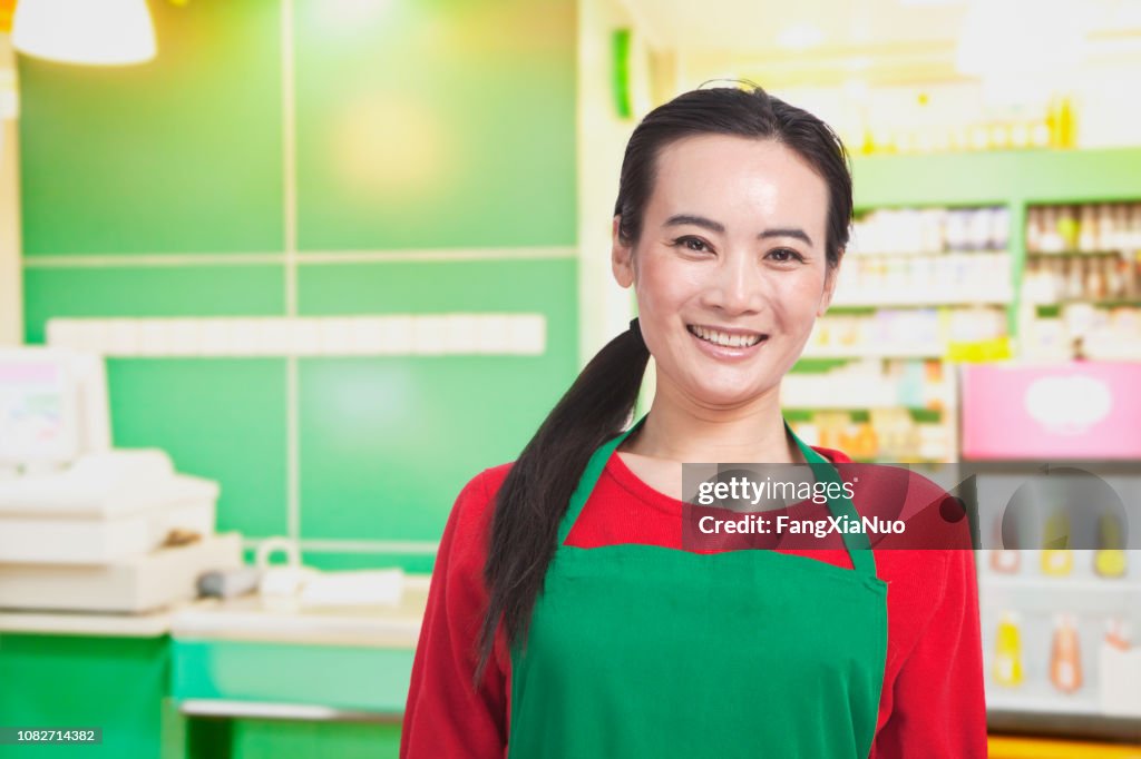 Smiling Chinese grocery store worker